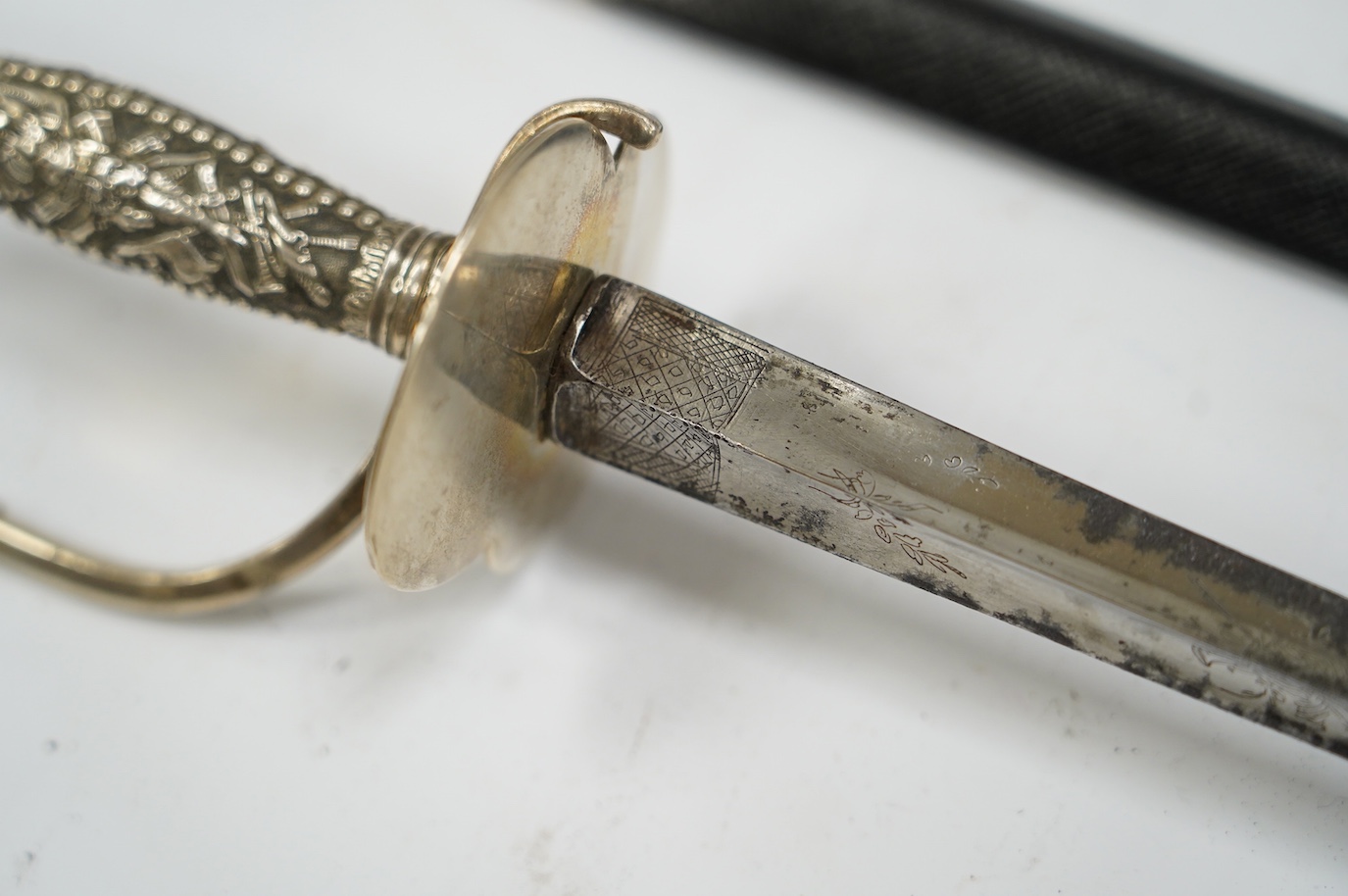 A late 18th century court sword with white metal grip, knuckle guard and mounts, decoration to scabbard band believe to be based on Admiral Duncan’s crest (Camperdown 1797), blade 84cm. Condition - fair to good, some wea